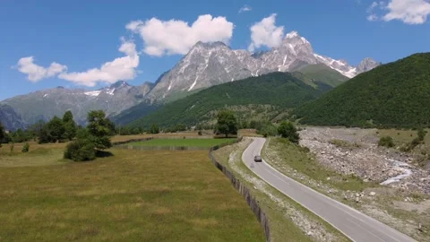 Car is driving on dirt road in mountain valley Stock Footage 301236155