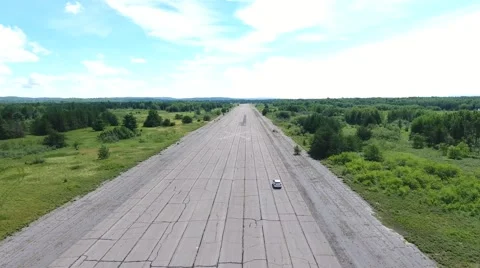 Car driving down abandoned runway 動画素材 68002028