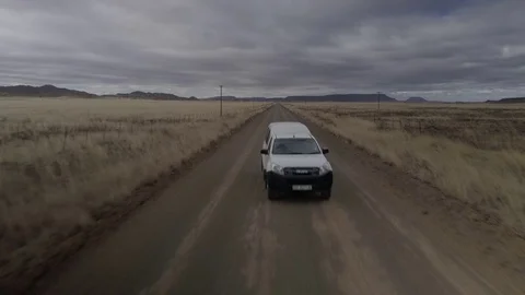 Car Driving Down and Empty Road Stock Footage 82628843