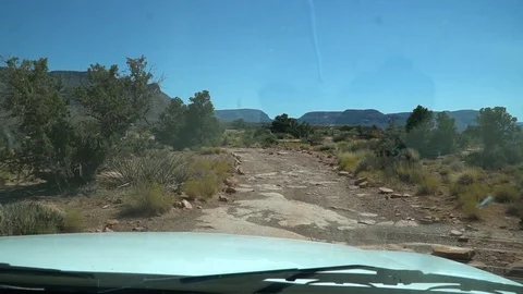 Car Driving down Bumpy Dirt Road Looking out the front window Video stock 128938691