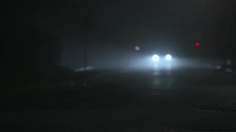A car driving down a bumpy road on a foggy night Stock Footage 233001973