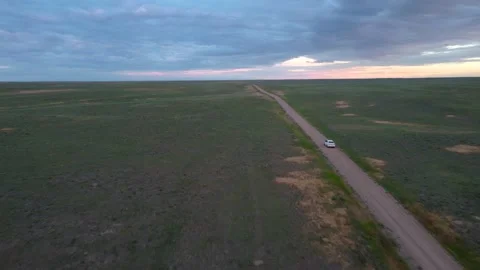 Car driving down dirt road Stock Footage 156558867