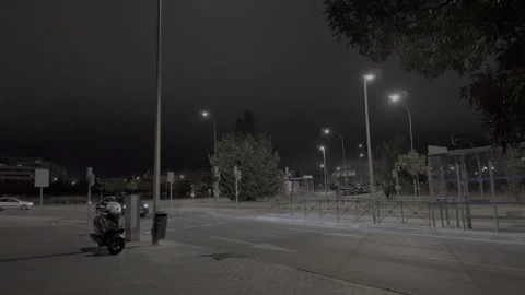 Car driving down an empty illuminated street at night Video stock 320539890