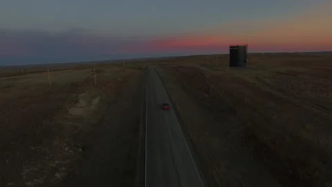 Car Driving Down Empty South Dakota Highway at Sunset. Stock Footage 145562198