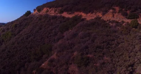 Car driving down empty winding road in the mountains Stock Footage 136341406