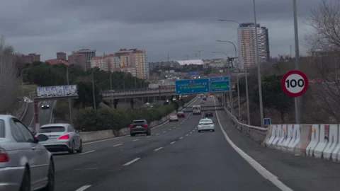 A car is driving down a highway with a blue arrow pointing to the right Stock-Footage 326956519