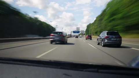 A car is driving down a highway with a bridge in the background Stock Footage 285160313