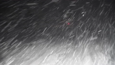 A Car Driving Down the Highway Through Snow and Blizzard Looking Through the Stock Footage 141038970