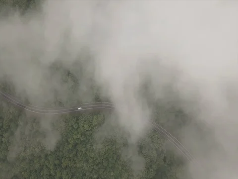 Car Driving Down Mountain Road into Clouds Видео 81315081