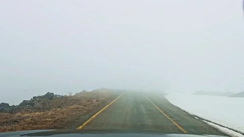 A car driving down a road covered in snow Stock Footage 272724088