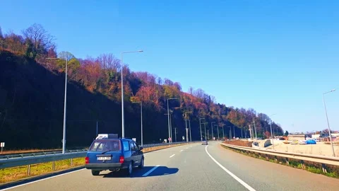 A car driving down a road with a mountain in the background Stock Footage 273013755