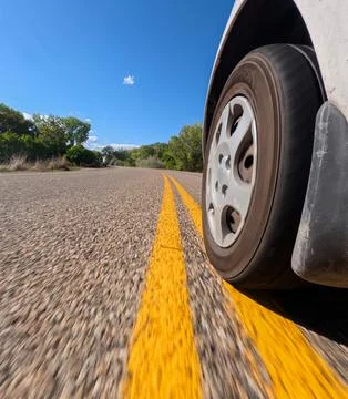 Car driving down the road Stock Photos