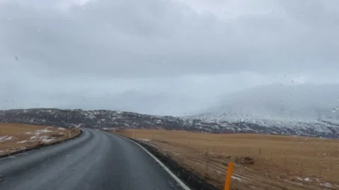 A car is driving down a road in the snow Stock Footage 305874212