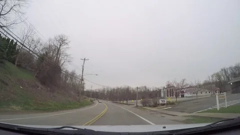 Car Driving Down Road Through Residential and Commercial Areas Stock Footage 74796138