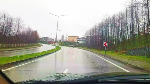 A car driving down a road with trees in the background Stock Footage 273015920