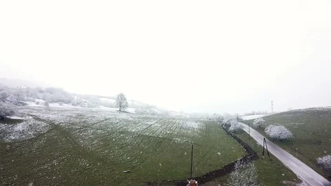 Car Driving Down Rural Road During A Spring Snow Storm Video stock 102405267