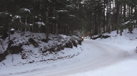 Car driving down a steep icy descent of a dangerous mountain road in winter Stock Footage 59159123