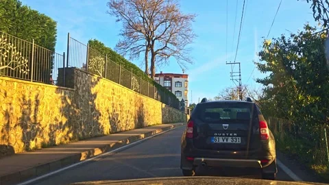 A car driving down a street next to a wall Stock Footage 272995010