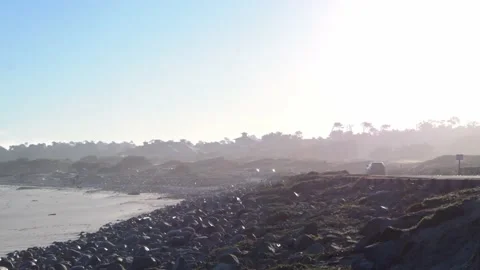 Car Driving Down Sun-Soaked Scenic Road Stock Footage 154383912