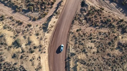 Car driving empty road - drone circular movement Stock Footage 107878866