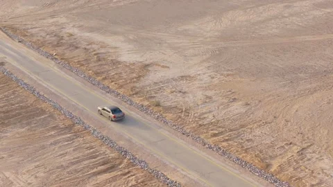 Car Driving on Empty Road Through Desert Landscape Aerial Drone View Stock Footage 346492576