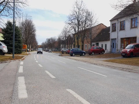 Car driving on empty small town street. Stock Footage 79987660