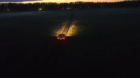 Car is driving on the field at night Stock Footage 102775290