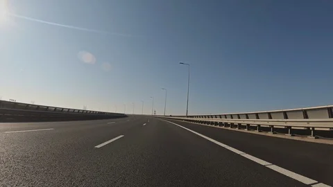 Car Driving On a Highway Viaduct or a Bridge by Day, POV Stock-Footage 129658945