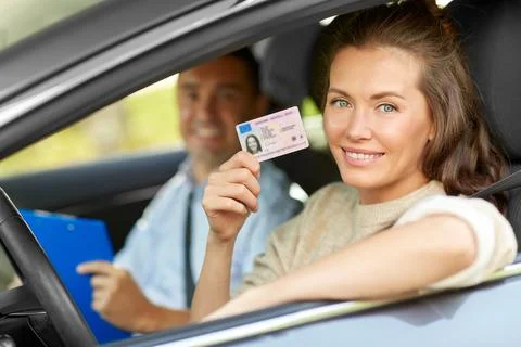 Car driving instructor and driver with license Stock Photos