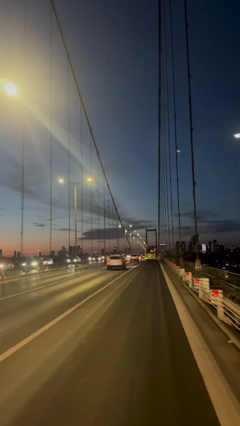 Car driving on large bridge at sunset. Beautiful cityscape roadway background. Stock Footage 307383218