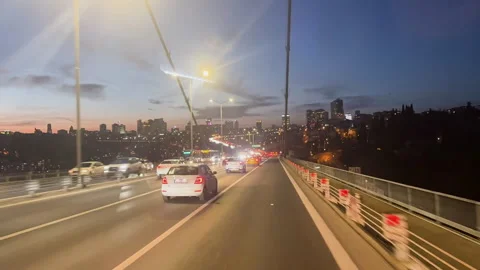 Car driving on large bridge at sunset. Beautiful cityscape roadway background. Stock Footage 307383777