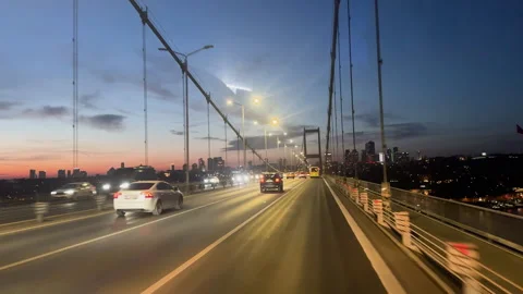 Car driving on large bridge at sunset. Beautiful cityscape roadway background. Stock Footage 307383874
