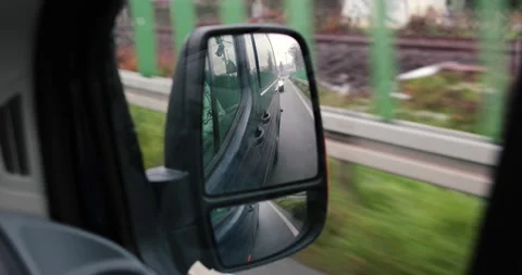 Car driving mirror reflection point of view driving through german streets Stock Footage 230487562