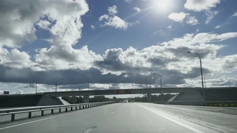 The car is driving on the motorway against the background of a blue sky. Stock-Footage 219751753