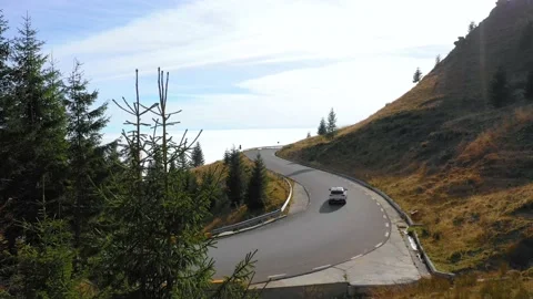 Car driving on the mountain road with forest. 4K aerial footage. Stock Footage 236203382