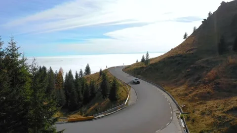 Car driving on the mountain road with forest. 4K aerial footage. 스톡 동영상 236203495