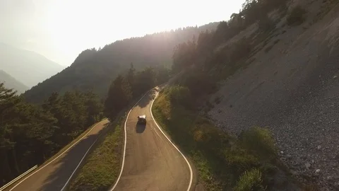 Car driving on a mountain road in the sunset, Verbier, Switzerland Stock Footage 101580244