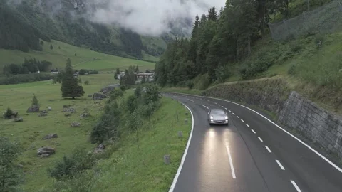 Car Driving on a Mountain Road Surrounded by Clouds Stock Footage 280307215