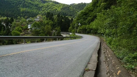 Car driving on mountain road through the green forest Stock Footage 88676466