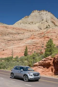 Car driving on a mountain road in Zion National Park in Utah Stock Photos