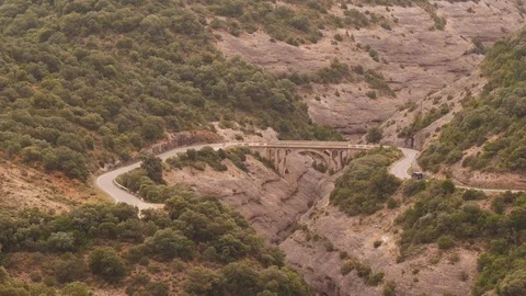 Car driving over bridge in Pyrenees mountains in Spain Stock Footage 98153566