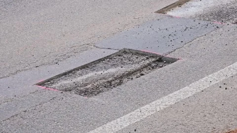 Car Driving over Cut Patch of Street Surface Asphalt Prepared for Roadworks Stock Footage 279388953