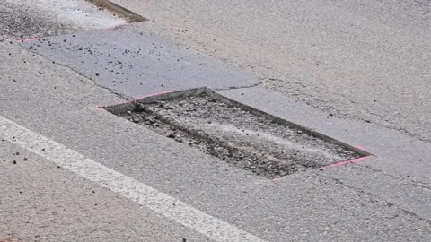 Car Driving over Cut Patch of Street Surface Asphalt Prepared for Roadworks Stock Footage 279389107