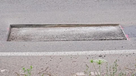 Car Driving over Cut Patch of Street Surface Asphalt Prepared for Roadworks Stock Footage 279389273