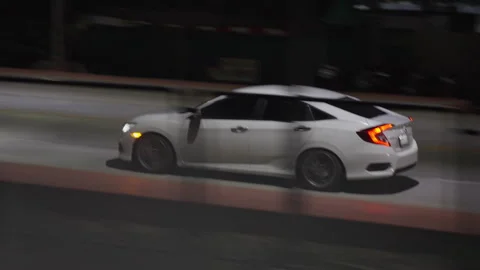 Car Driving Parallel to Moving Train at Night in Thailand, Tracking Shot Stock Footage 337532678