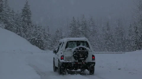 A car driving past camera in snow storm Stock Footage 1085076