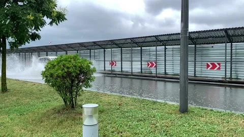 Car driving in a puddle, slow motion Stock Footage 162223562