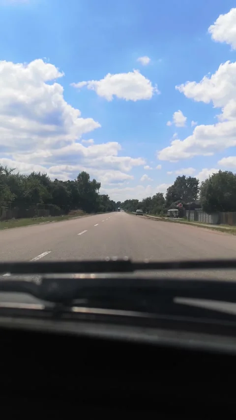 Car driving quickly through a charming Ukrainian village in summer, Sumy region Stock Footage 295874692