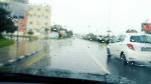 Car driving in the rain in daytime. Stock Footage 289440656