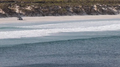 Car driving on remote surf beach on sunny summer day in South Australia Stock Footage 123458039